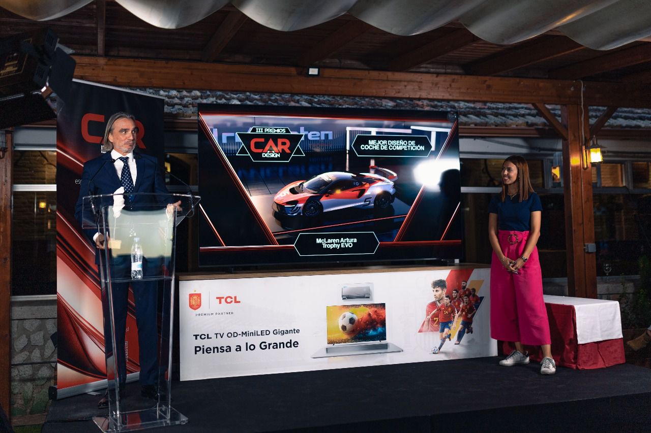 Laura Martín González, responsable de prensa de la Real Federación Española del Automovilismo entrega el premio a Mario Camacho, responsable de comunicación de McLaren en España